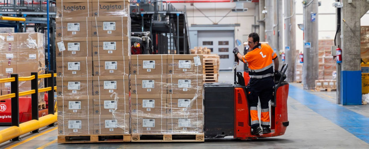 Logista Freight worker moving pallets with a forklift